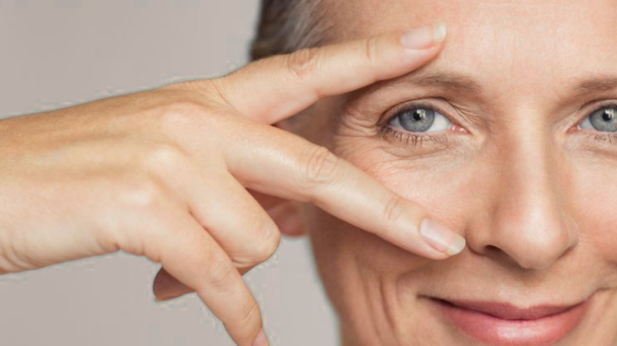 Women with fingers around eye
