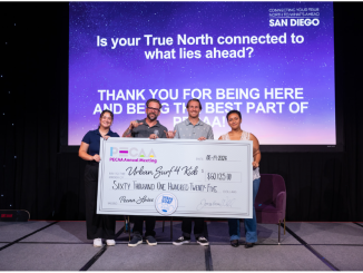 Urban Surf 4 Kids accepting big donation check.