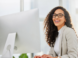 Woman smiling at computer.